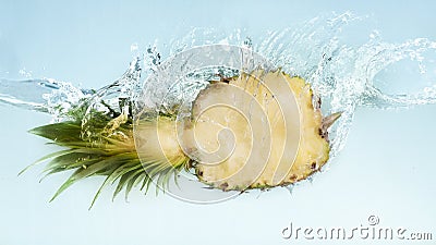 Pineapple half falling underwater with big splash Stock Photo
