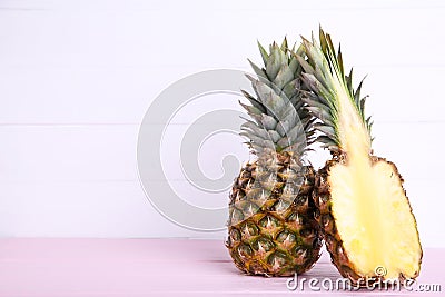 Pineapple and half of pineapple on a white wooden background Stock Photo