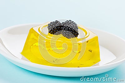 Pineapple jelly pudding decorated blackberries on a white plate Stock Photo