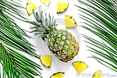 Pineapple and palm branch on white background top view Stock Photo