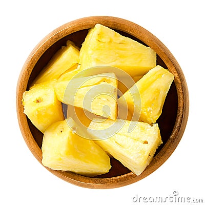 Pineapple pieces in wooden bowl over white Stock Photo