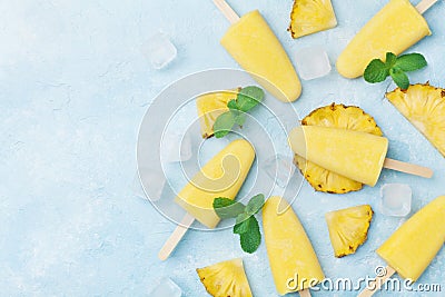 Pineapple popsicles or homemade ice cream top view. Summer refreshing food. Frozen fruit pulp. Stock Photo