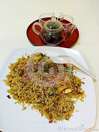 Pineapple rice and pu& x27;er tea in pot with teacups Stock Photo