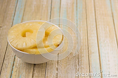 Pineapple rings in a white bowl. Canned ananas slices, copy space Stock Photo