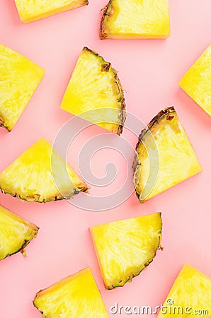 Pineapple slices on pink background. Tropical juicy exotic healthy fruit texture. Top view, flat lay, minimal. Stock Photo