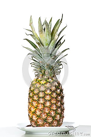 Pineapple stands on a table. Stock Photo