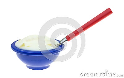 Pineapple yogurt in a blue dish with spoon Stock Photo