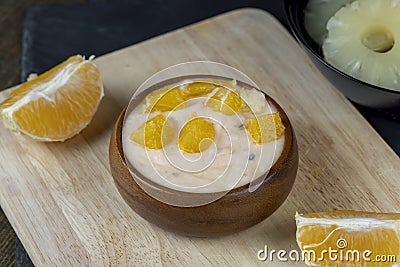 pineapple yogurt with slices of ripe yellow orange Stock Photo