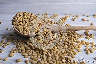 Pinenuts in the wooden spoon Stock Photo