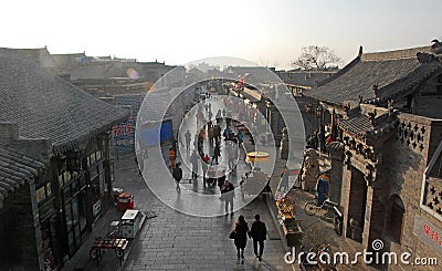 Pingyao in Shanxi Province China: View overlooking a street with traditional buildings and street vendors in Pingyao old town Editorial Stock Photo