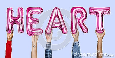 Pink alphabet balloons forming the word heart Stock Photo