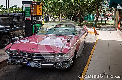 Pink american classic car on the gas station in Havana Cuba Editorial Stock Photo