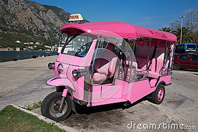 Pink auto rickshaw or tuk-tuk on the street of Kotor. Montenegro Editorial Stock Photo