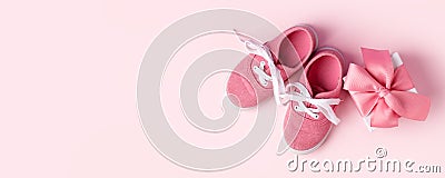 Pink baby shoes and gift present box, concept of first steps, birthday, expectation, pregnancy, maternity, motherhood, parenthood Stock Photo