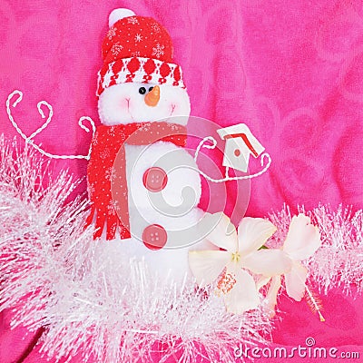 Pink background Christmas red snow white snowman soft toy with white hibiscus flowers and white tinsel Stock Photo