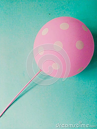 Pink balloon hanging on the wall Stock Photo