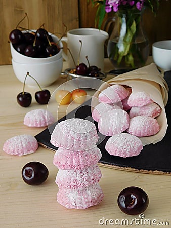 Pink berry marshmallows zephyr are scattered out of a paper bag Stock Photo