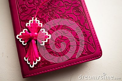 Pink Bible with handmade pink cross on it Stock Photo