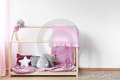 Pink blanket on girls bed Stock Photo