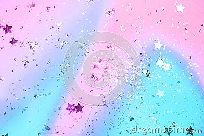 Pink and blue confetti and stars and sparkles on pink background Stock Photo