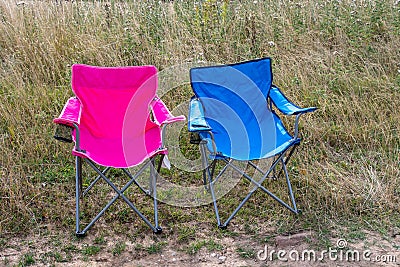 Pink and blue folding camping chairs Stock Photo