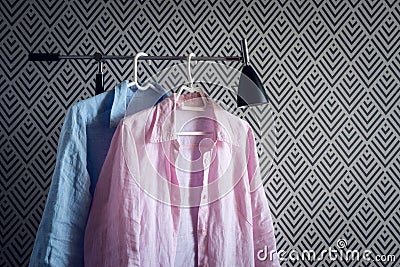 Pink and blue shirts on wallpaper background Stock Photo