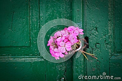Pink bouquet on old door Stock Photo