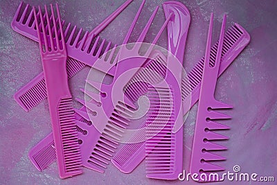 Pink bright comb for hairdressers. Beauty saloon. Tools for hairstyles. Colorful pink background. Barbershop. A set of different Stock Photo