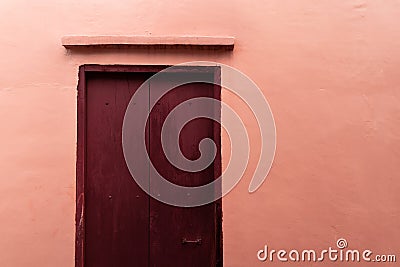 Pink brown door with pink cement wall architecture background Stock Photo
