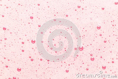 Pink bubbles on the surface of the water. Background for cosmetics, hygiene and washing Stock Photo