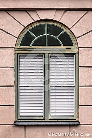 Pink building with rounded green window Stock Photo