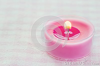 Pink burning candle on a romantic soft background Stock Photo