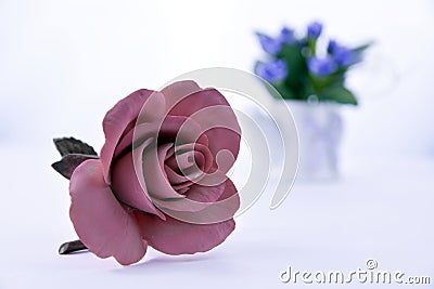 Pink ceramic rose on a white background with flowers Stock Photo