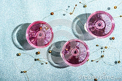 Pink champagne in crystal glasses on shiny mint blur background. New year celebration party with girly glam drink. Nightclub party Stock Photo