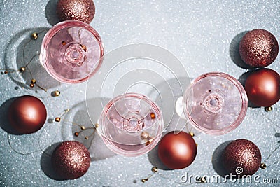 Pink champagne in crystal glasses on shiny mint blur background. New year celebration party with girly glam drink. Nightclub party Stock Photo