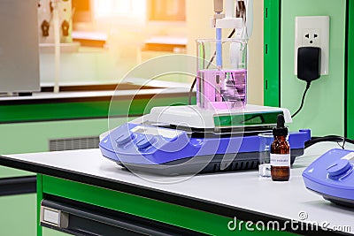 Pink chemical substance in beaker placed on magnetic stirrer Stock Photo