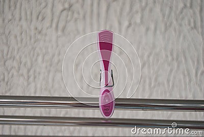 Pink clip for linen on a metal tube Stock Photo