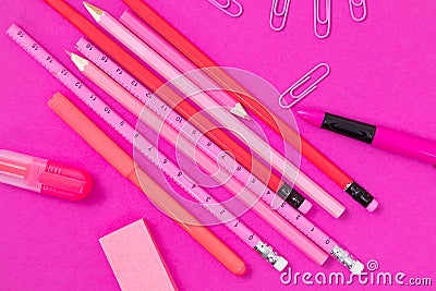 Pink color writing equipment scattered on pink surface isolated Stock Photo