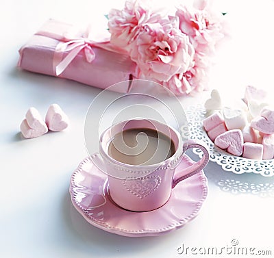 Pink cup with coffee, marshmallows hearts, gift and bouquet of pink roses Stock Photo