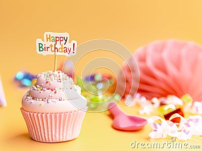 Pink cupcake with Happy Birthday text on beige background Stock Photo