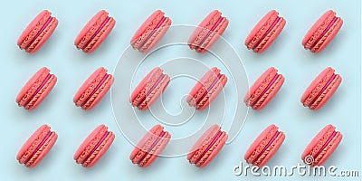 Pink dessert cake macaron or macaroon on trendy pastel blue background top view. Flat lay pattern composition Stock Photo