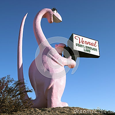 Pink dinosaur holding sign Stock Photo