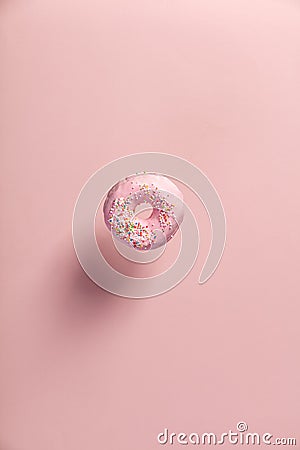 Pink doughnut with sprinkles falling or flying in motion Stock Photo