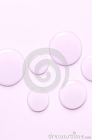 Pink drops of moisturizing gel or serum. Cosmetic product for skin care. Copy space. Stock Photo