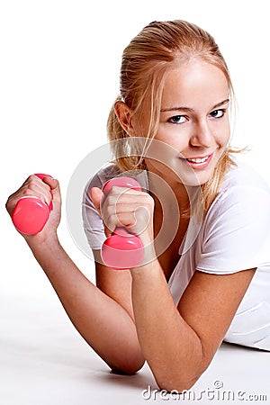 Pink dumbbells in the hands of women Stock Photo