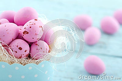 Pink easter eggs in a blue cupcake cup Stock Photo