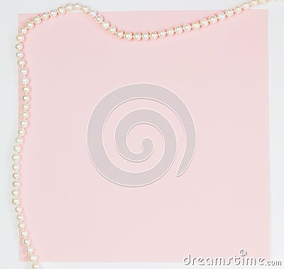 Pink empty card, sheet for writing. Layout for adding tags with a pearl necklace. Top view, flat lay, copy space Stock Photo