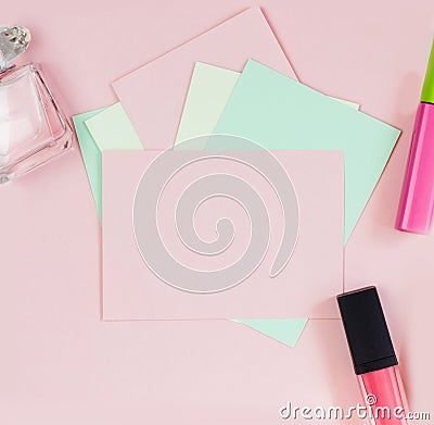 Pink empty card, sheet for writing. Layout for adding tags with perfume and lipstick. Top view, flat lay, copy space Stock Photo