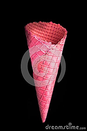 Pink empty wafer cone on dark background Stock Photo
