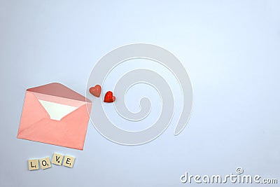 Pink envelop with love letter on pastel flat lay background, valentine\'s day red hearts composition, feelings concept, copy space Stock Photo